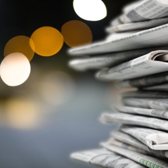 Pile of newspapers on blur background